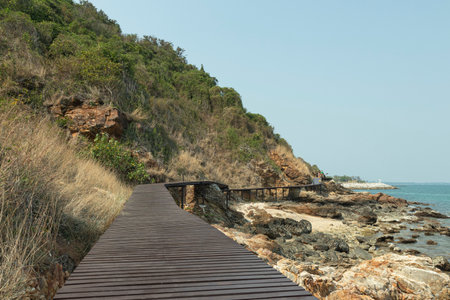 brown wooden bridges along the hillsides rocks on the beach are rocks and  rocky mountains and sea close to island, eco-tourism conceptの写真素材