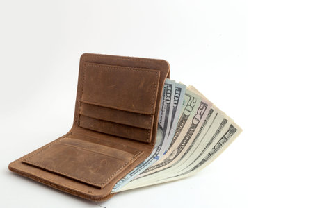 wallet with dollars sticking out of it