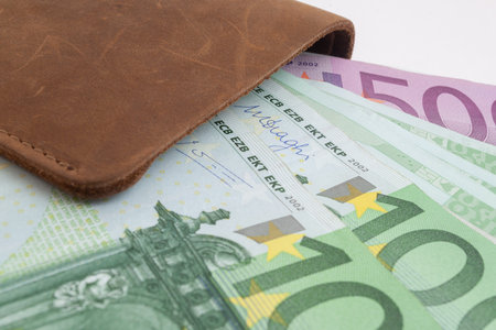 wallet with euro sticking out of it