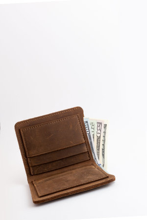 wallet with dollars sticking out of it