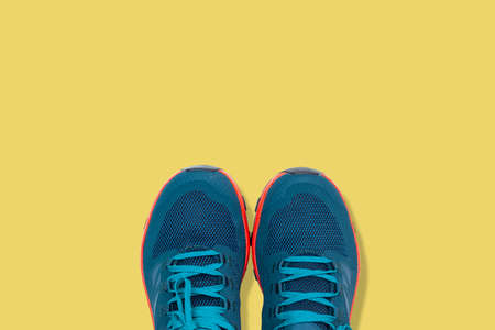 blue sneakers on a yellow backgroundの写真素材