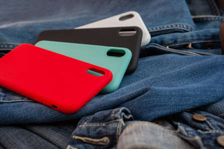 multi-colored mobile phone case on a denim backgroundの写真素材