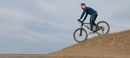 panorama Bearded mountain bicyclist rides mountainsの写真素材