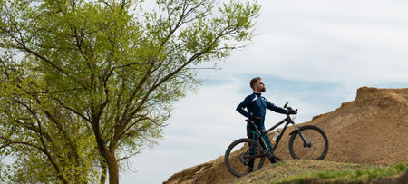 panorama Bearded mountain bicyclist rides mountains and forestの写真素材