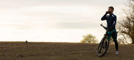 panorama cyclist rides through the woodsの写真素材