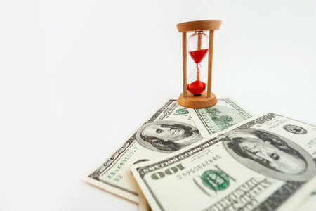 100 dollar bill with hourglass on white isolated background