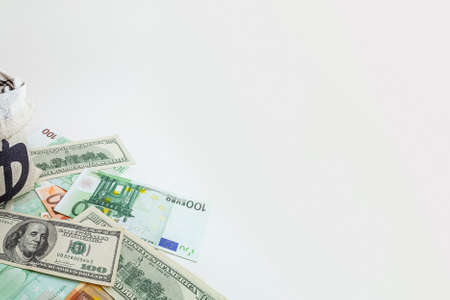 panorama pouch with coins and bitcoins on us dollar and euro banknotesの写真素材