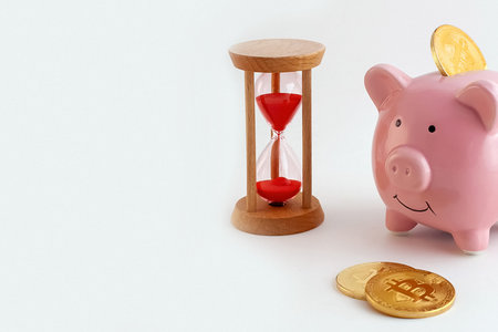 panorama Piggy bank with bitcoin coins and hourglass on isolated white background