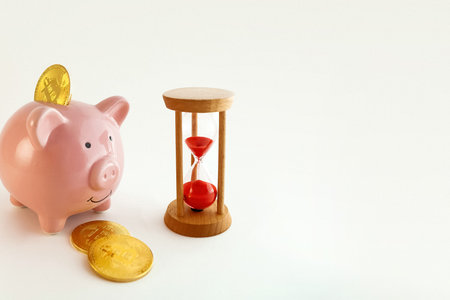 panorama Piggy bank with bitcoin coins and hourglass on isolated white background
