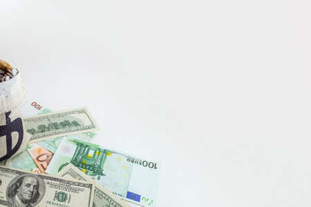 panorama pouch with coins and bitcoins on us dollar and euro banknotesの写真素材