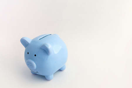 Piggy bank in the shape of a pig on an isolated white backgroundの写真素材