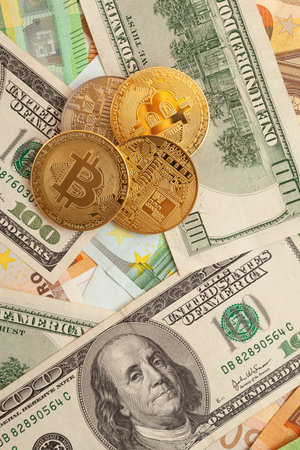 bitcoins on a texture background of euro and dollars