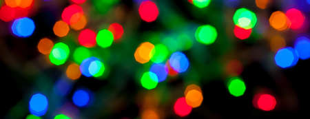 panorama bokeh texture of multicolored christmas and new year lightsの写真素材