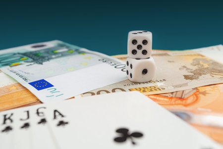 Chisinau, Moldova - 20. 12. 2020 dice, playing cards on a green cloth in a casino dollars and euro...