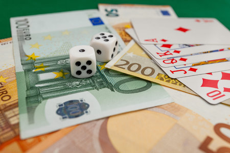 Chisinau, Moldova - 20. 12. 2020 dice, playing cards on a green cloth in a casino dollars and euro...