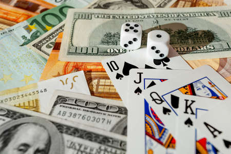dice, playing cards on a green cloth in a casino dollars and euro billsの写真素材