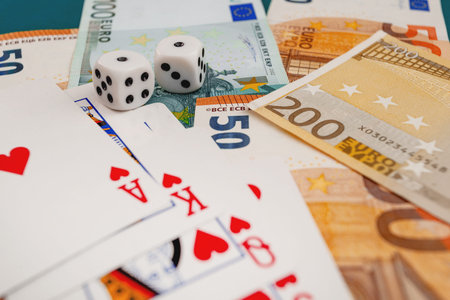 Chisinau, Moldova - 20. 12. 2020 dice, playing cards on a green cloth in a casino dollars and euro...