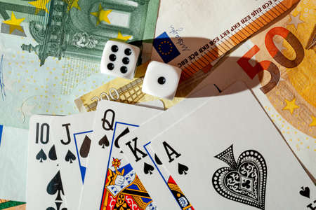 Chisinau, Moldova - 20.12.2020 dice, playing cards on a green cloth in a casino dollars and euro billsの写真素材