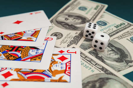 Chisinau, Moldova - 20.12.2020 dice, playing cards on a green cloth in a casino dollars and euro billsのeditorial素材