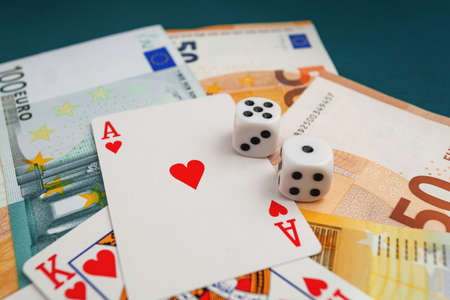 Chisinau, Moldova - 20.12.2020 dice, playing cards on a green cloth in a casino dollars and euro billsのeditorial素材