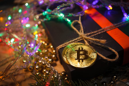 Christmas bitcoin garland gifts and fir branchesの写真素材