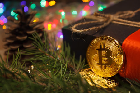 Christmas bitcoin garland gifts and fir branchesの写真素材
