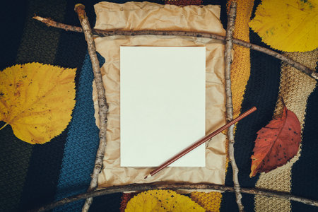 Autumn mockup with yellow, red leaves. Fir cones and a white sheet of paper for the inscription.