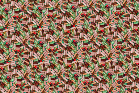 multicolored pills and capsules on a green background