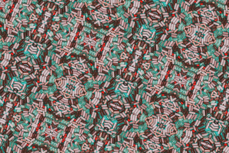 multicolored pills and capsules on a green background