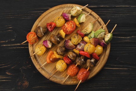 Top view of vegetable skewers on a wooden background.の写真素材