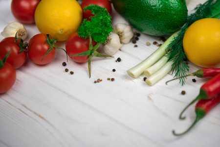 Mix of fresh bright fruits and vegetables on the white wooden background. Healthy eating, vegetarian food concept. Mock up, place for your text.の写真素材