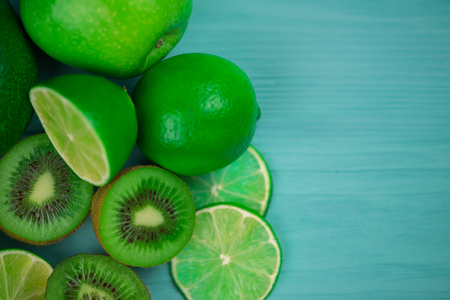 Mix of fresh green fruits on the wooden turquiose background. Mock up, copy space for your text.の写真素材