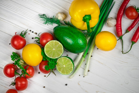 Mix of fresh bright fruits and vegetables on the white wooden background.の写真素材