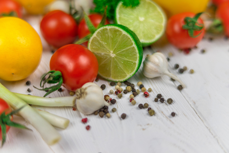 Mix of fresh bright fruits and vegetables on the white wooden background.の写真素材