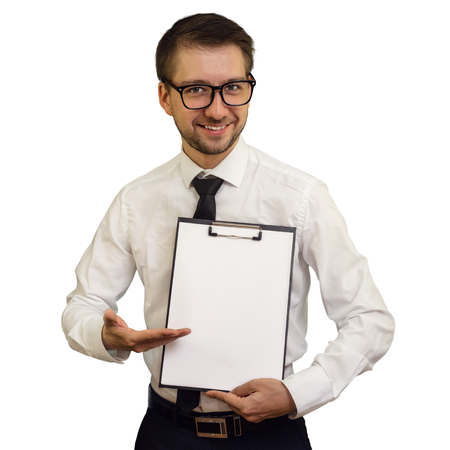 Young smiling business consultant pointing at notepad with blank sheet making presentation. Isolated on white background. Mock up, copy space for your text.の写真素材