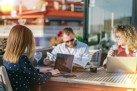 Young business team having meeting to make out new fresh ideas for their next project. Group of freelancers brainstorming together sitting on a terrace.の写真素材
