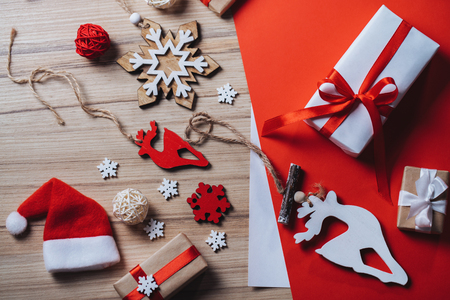 Christmas composition. Holiday decorations and gifts on wooden background. Top view, flat lay.の写真素材