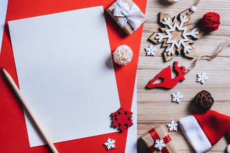 Christmas composition of pine tree decorations and gift boxes with blank piece of paper to write best wishes. Mock up, copy space for your text. Top view, flat lay.の写真素材