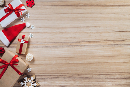 Christmas concept. Border of pine tree decorations and gift boxes on wooden background. Top view, flat lay. Copy space for your text.の写真素材