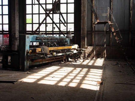 Disassembled Metalworking machines in an abandoned factory, close-up.の写真素材
