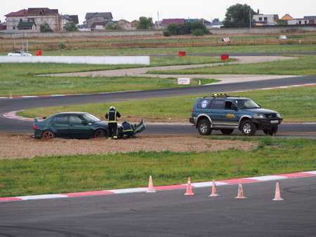 Myachkovo village, Moscow region, Russia-August 15, 2020 Car festival "DriftExpo", emergency marshals provide assistance to the driver on the race track.のeditorial素材