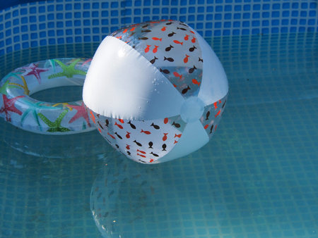 An inflatable ball and a children's circle in the pool. summer fun. equipment for recreation and...