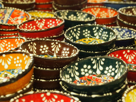 Ceramic tableware with natural patterns painted, close-up. Objects of ethnic crafts, small business,...