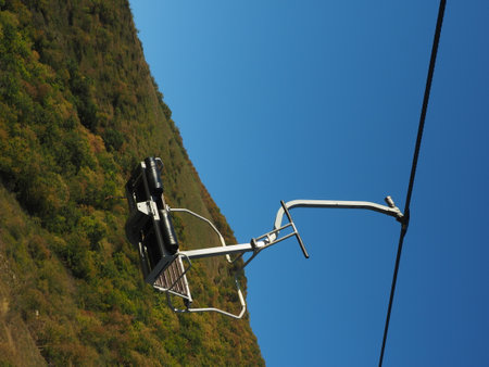 Cable car in the mountains on a background of blue sky.の写真素材