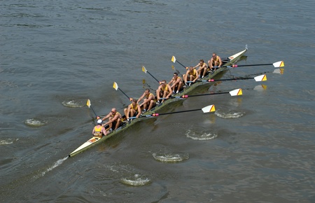 Rowing team rowing ahead during a boat-race on the River Vltava in Prague, Czech Republic