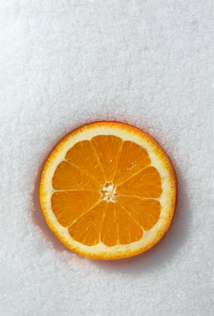 Orange on snow. Vitamins in the winter timeの写真素材