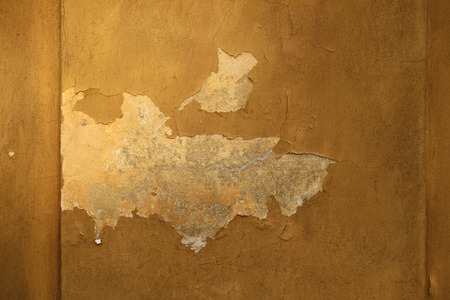 Old wall with cracked plaster. Background texture.の写真素材