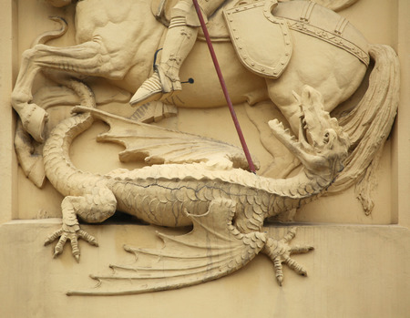 Dragon killed by Saint George. Stucco decoration on the Art Nouveau building in Prague, Czech Republic.のeditorial素材