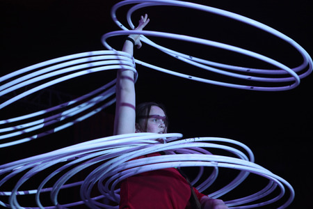 DRESDEN, GERMANY - MARCH 31, 2014: Hula hoop juggler Alexandra Soboleva (Ukraine) performs with Russian Grand Circus in Dresden, Germany, on March 31, 2014.のeditorial素材