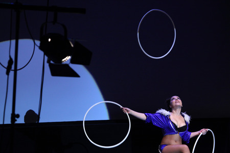 KARLOVY VARY, CZECH REPUBLIC - MAY 8, 2013: Hula hoop juggler Jessica performs with Russian Grand Circus in Karlovy Vary, Czech Republic, on May 8, 2013.のeditorial素材